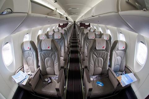 Interior picture of a regional jet with 4 seats across